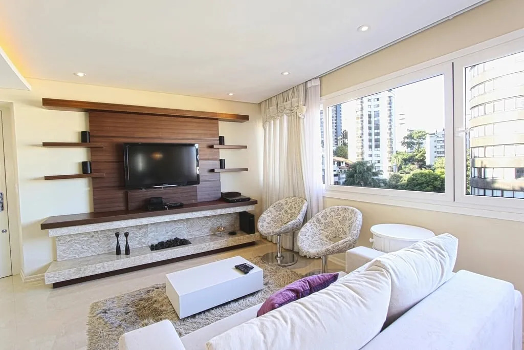 A bright, freshly cleaned living room with a sofa and area rug